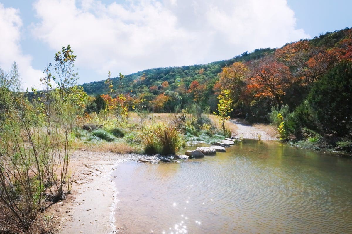 A peaceful Hill Country river scene — the kind of setting you'll find on the Llano, Blanco, and South Llano