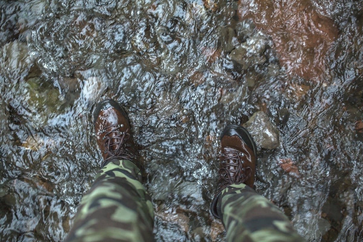 Proper wading gear is a safety requirement, not optional — studded boots, wading belt, and a staff are the minimum for Great Lakes tributaries