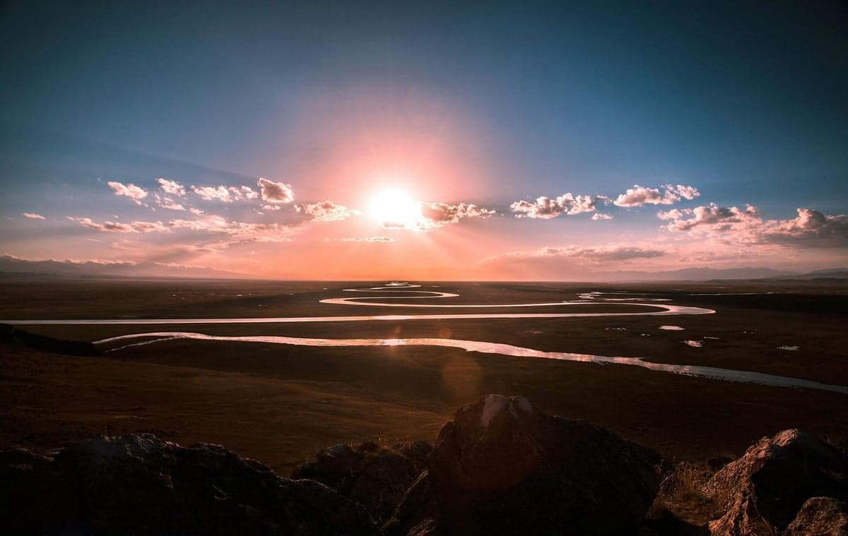 Sunrise over the Bighorn River winding through Montana prairie grasslands