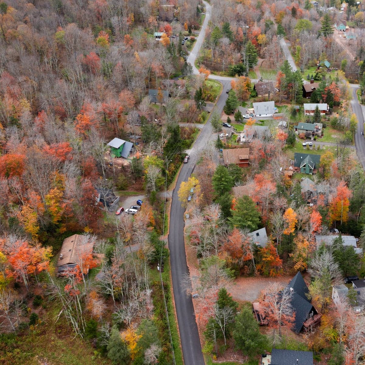 Aerial view of a Catskill village in autumn. Towns like Roscoe, Livingston Manor, and Hancock serve as base camps for Delaware River anglers.