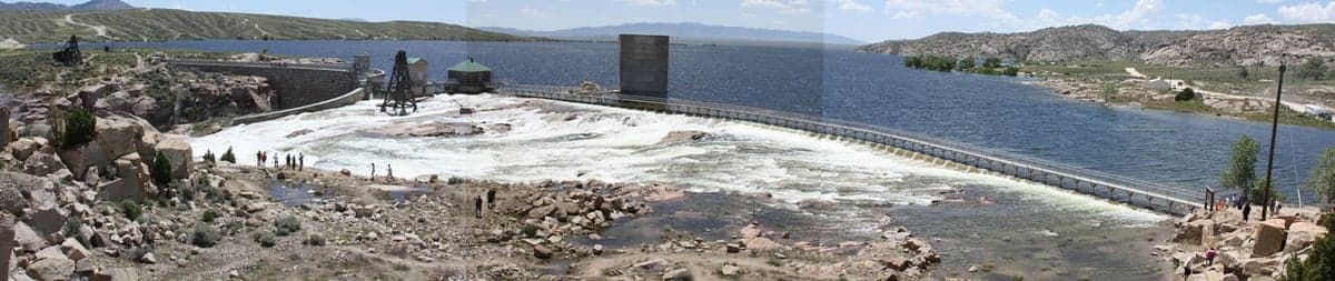 Pathfinder Dam spilling in June 2010, about 45 miles southwest of Casper. Pathfinder is the storage end of this chain: what it holds back runs down through Fremont Canyon into Alcova, Alcova swings it for hydropower, and Gray Reef smooths those swings into the steady flow you actually fish.