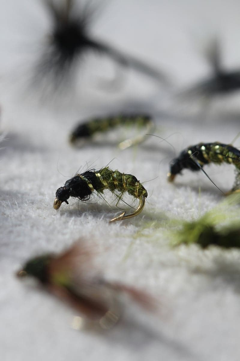 A Deckers box leans small. Midges and Baetis carry more than half the year, with a short window in summer where you can size up.
