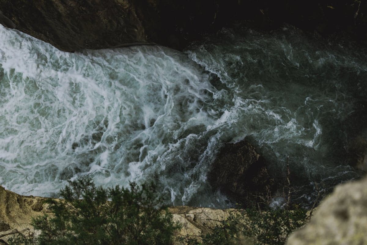 Aerial view of a river canyon with whitewater, similar to the Yellowstone's Yankee Jim Canyon where Class III-IV rapids challenge rafters and kayakers during high water